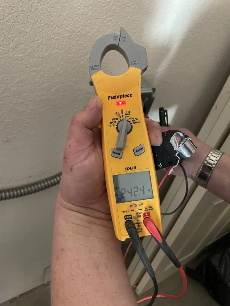 Voltage testing with clamp meter during Whole House Surge Protector in Grayson
